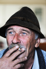 Aged Man With  Grey Mustache Smoking Cigarette