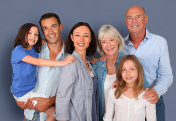 Portrait of happy family standing ion grey background
