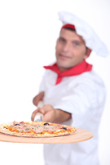 Pizza chef with a wooden board
