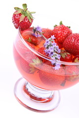 Jelly with strawberries decorated with a lavender twig in a cup