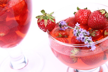 Jelly with strawberries in glass cups on white background