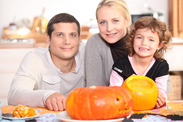 Family carving pumpkins together