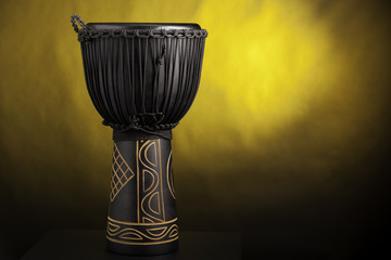 Black Djembe Drum Isolated on Yellow Spotlight
