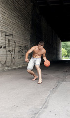 Fototapeta na wymiar bare-chested guy playing basketball