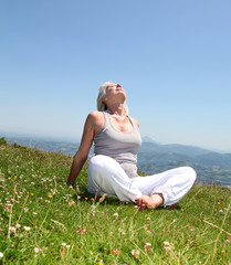Senior woman doing stretching exercises in countryside