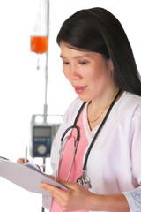 Attractive female nurse in clinic environment with chart