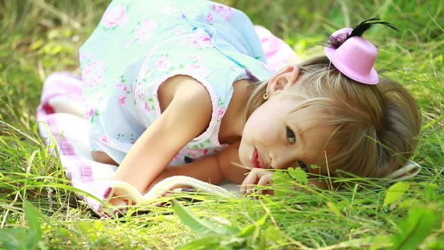Little girl lying in grass