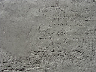 gray painted worn brick and concrete wall