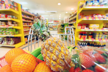 Moving shopping cart in supermarket.