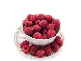 fresh raspberries in vintage cup isolated over white