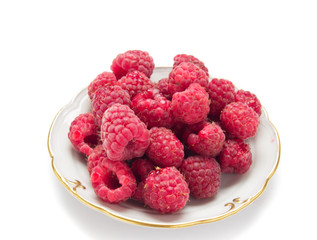 fresh raspberries in plate isolated over white background