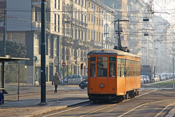 Old vintage orange tram on the street of Milan, Italy