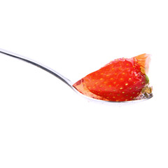 Jelly with a strawberry on a spoon on white background
