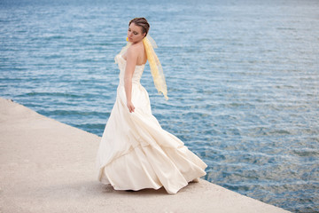 Fototapeta na wymiar Bride posing showing her wedding dress