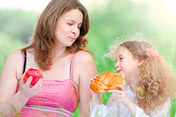 young mother and her daughter eating