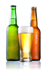 Brown and green bottles full of condensate and covered with a gl
