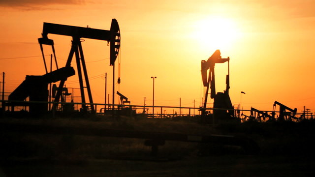 Oil Donkeys Producing Oil at Sunset