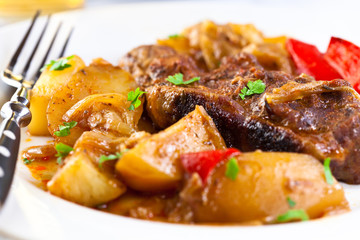 Rustic meat dish with potatoes,sauce and fresh parsley