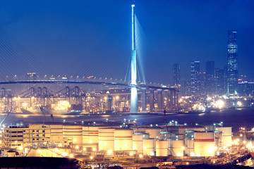 gas container and bridge at night