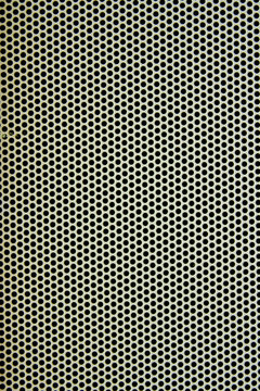 White metal plate with many small circular holes