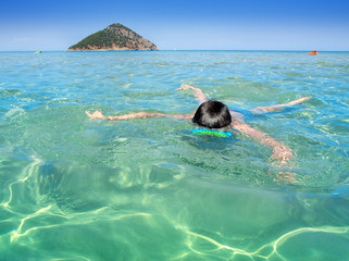 Boy diving in the turquoise sea