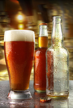 Glass of beer with bottles
