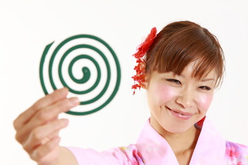Young woman wearing Japanese kimono with mosquito coil