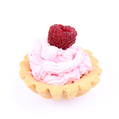 Tartlet with whipped cream and a raspberry on a white