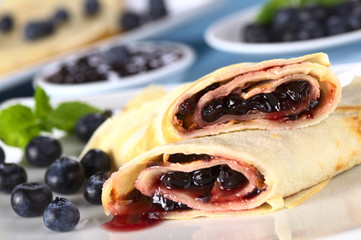 Pancakes filled with blueberry jam with fresh blueberries