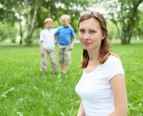 Fototapeta premium Portrait of mother with two sons on the background