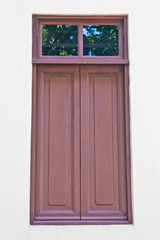 House window made from wood over white wall