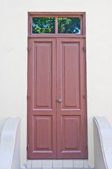 House door made from wood over white wall