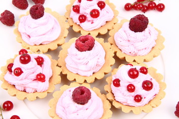Tartlets with whipped cream and raspberries or redcurrants