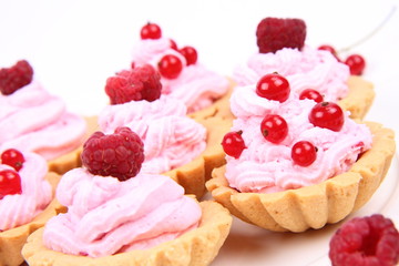 Tartlets with whipped cream and raspberries or redcurrants