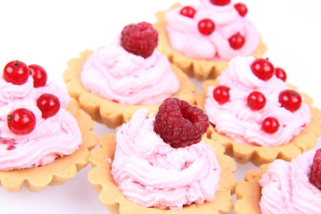 Tartlets with whipped cream and raspberries or redcurrants