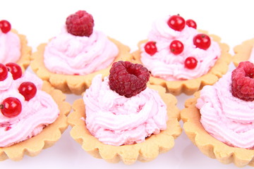 Tartlets with whipped cream and raspberries or redcurrants