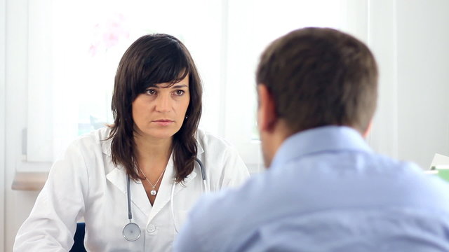 Female doctor telling bad news to male patient