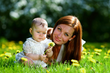 Mother and daughter on the green grass