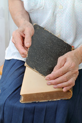 Old hands open an old book