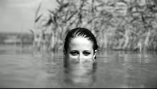 Girl in the river. Video in noisy black and white style.