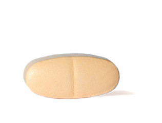 Herbal pill on a white background