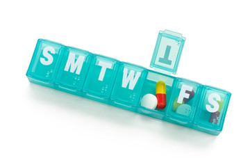 A weekly dosage of medication in pill dispenser.