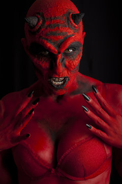 Sexy red devil, black background.