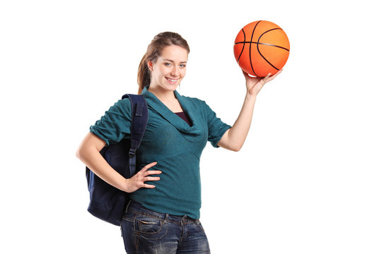 Young school girl holding a basketball