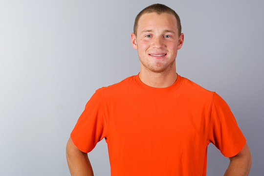 Handsome young man in an orange shirt