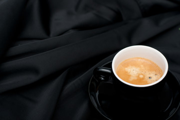 Cup of Coffee on Black Drapery