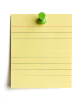 Yellow note pad pinned on white background