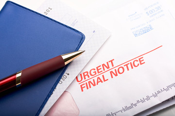 Closeup of checkbook and mail labeled urgent final notice