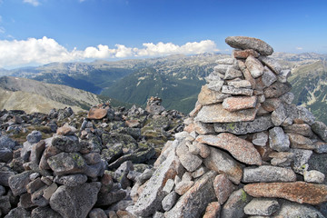 stone pyramid on top of mountain peak