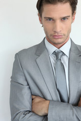 Young businessman with arms crossed